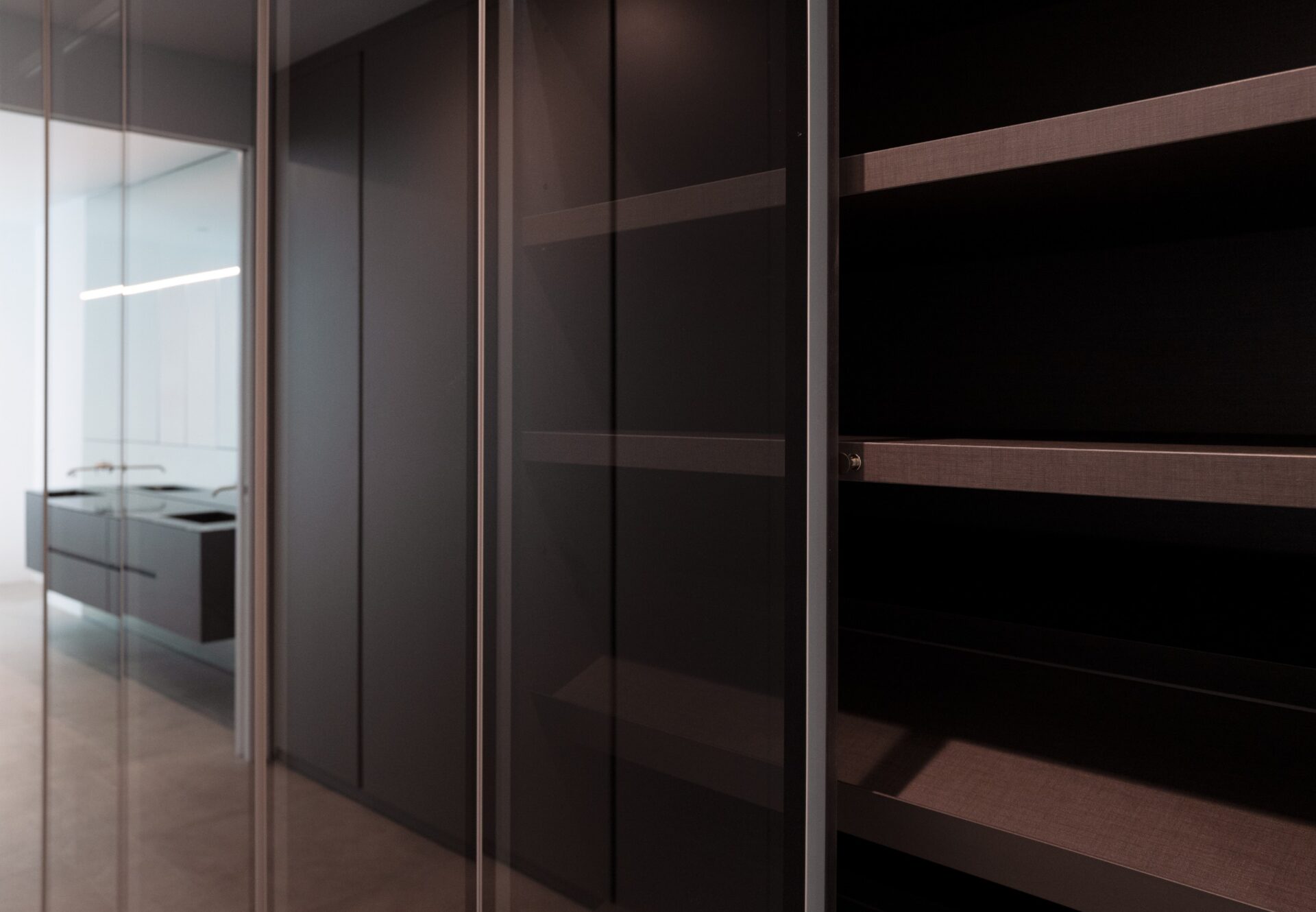 Flush closet with integrated lighting and matte lacquer finish in a luxury West Hollywood apartment.