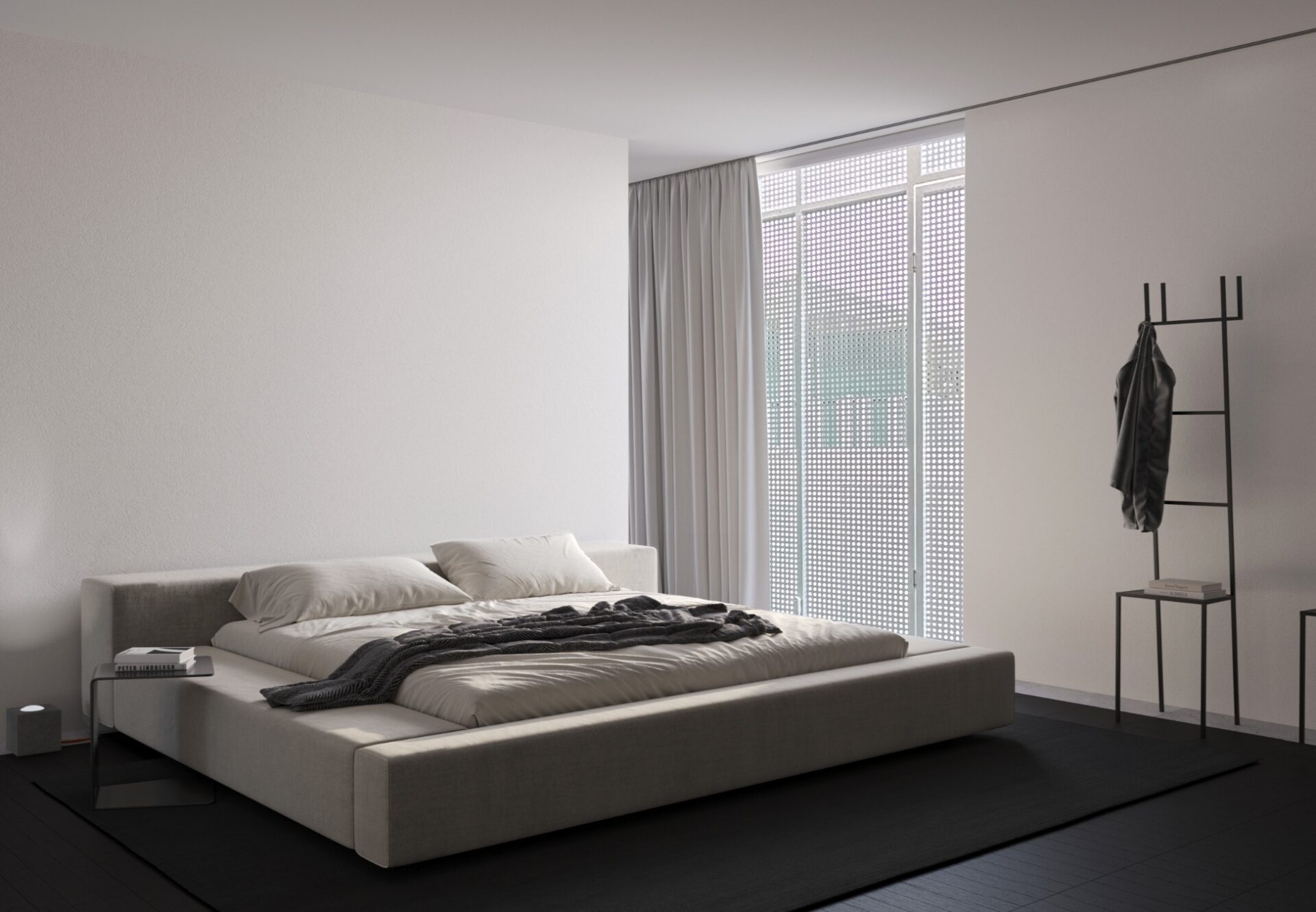 Minimalist bedroom with a platform bed, tall sheer curtains, and modern black coat racks by the window.