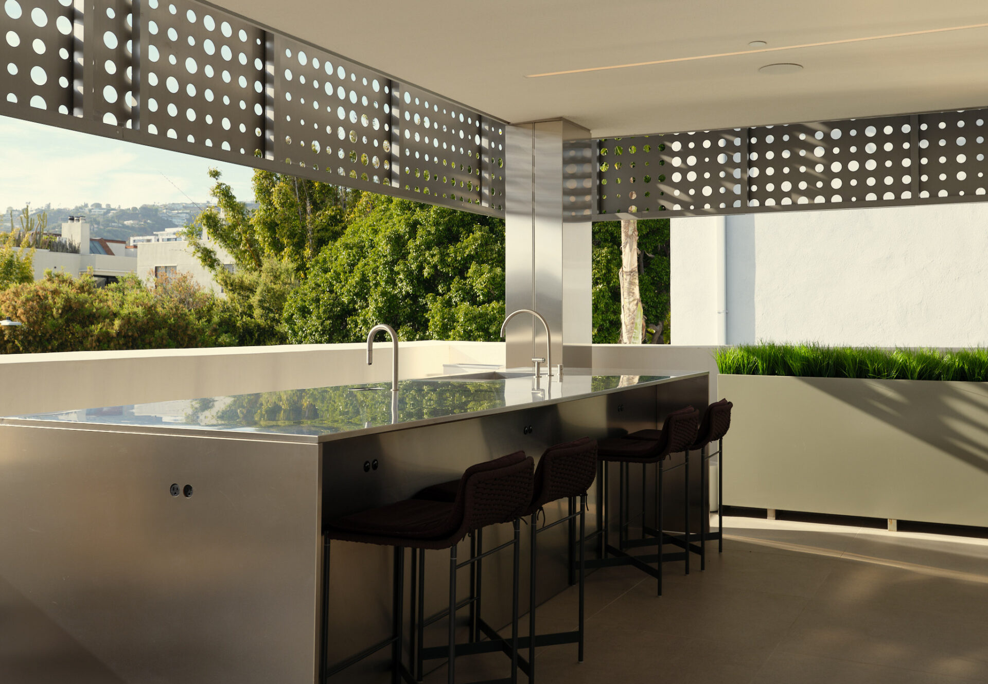 Rooftop cafe with stainless steel counter, perforated shade panels, and automated barista system overlooking Hollywood Hills.