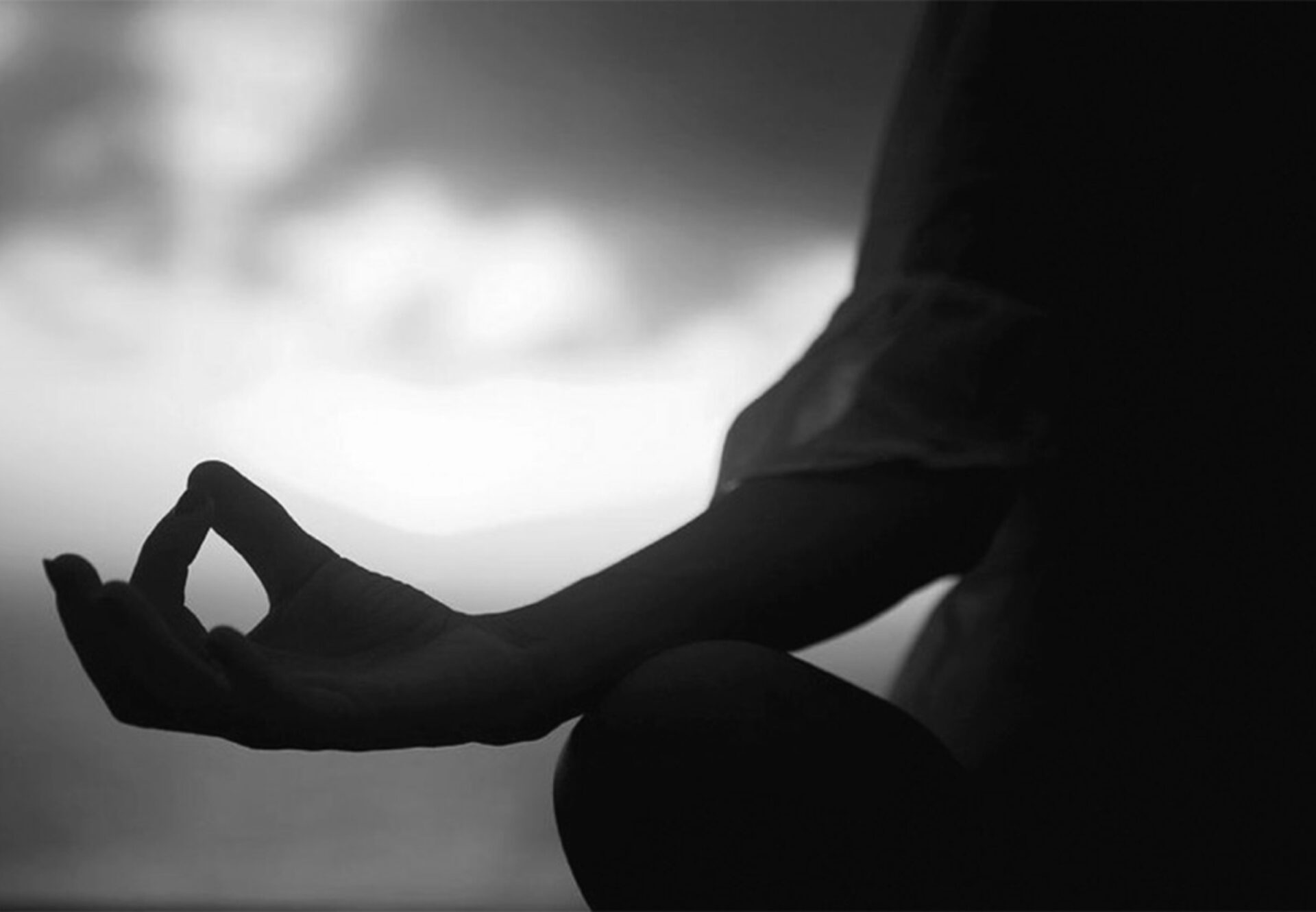 Meditative pose captured in soft lighting, symbolizing mindfulness and calm as part of the wellness lifestyle at the rooftop terrace.