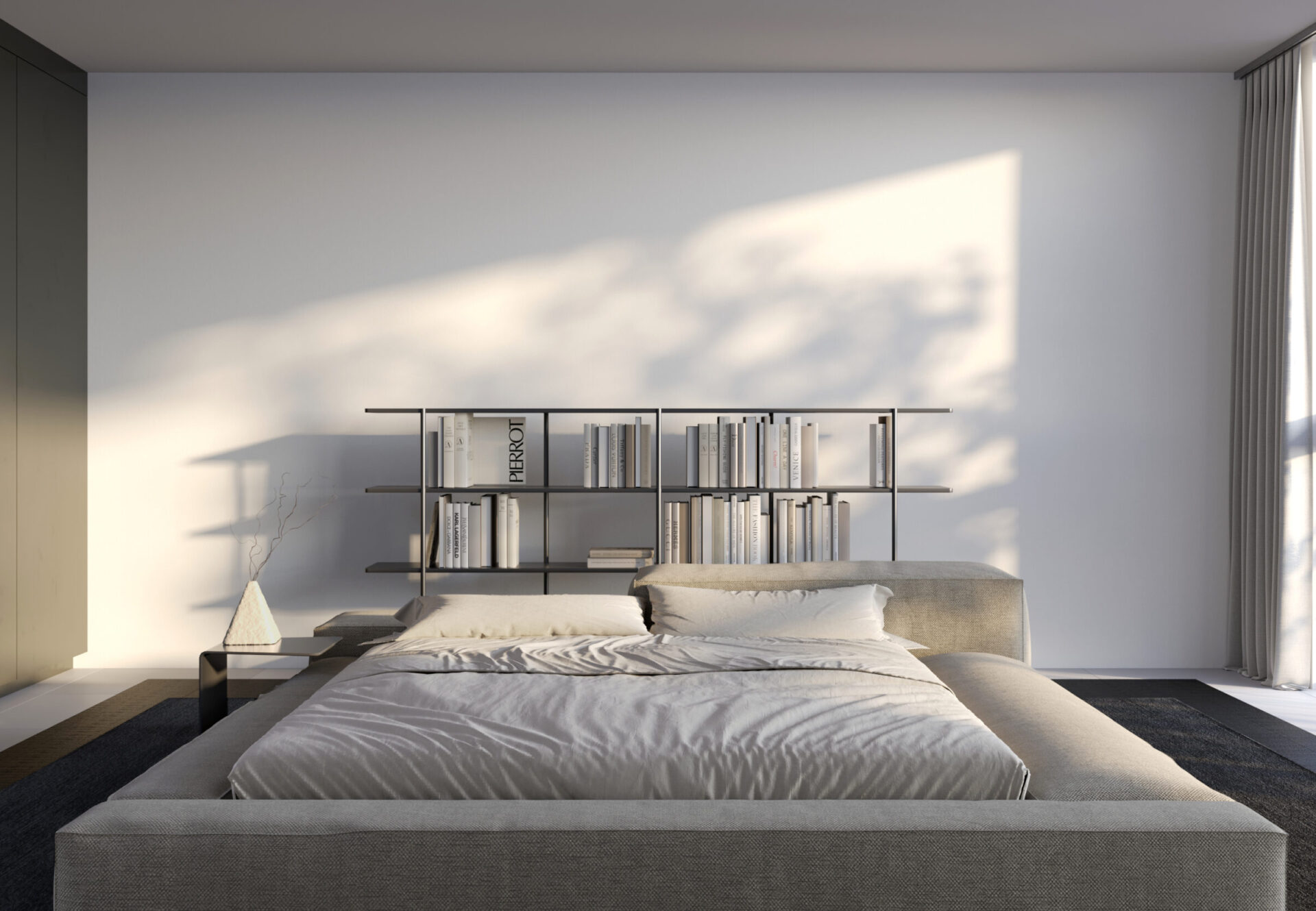 Sunlit bedroom with a platform bed and built-in bookshelf headboard, featuring soft morning light casting shadows on the wall.
