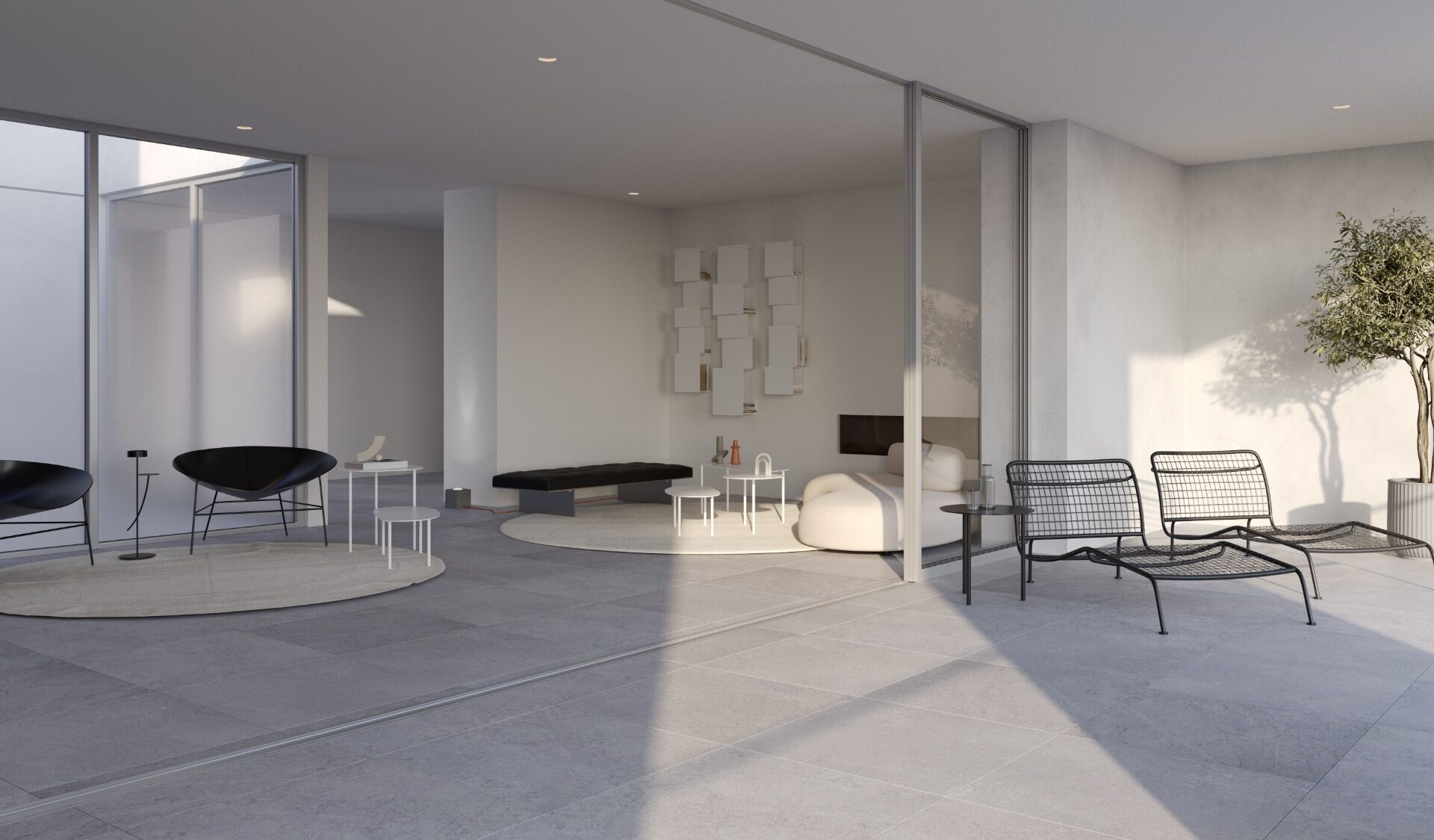 Luxury two-bedroom penthouse living room with flush flooring to private terrace, sculptural lounge seating, and refined decor.