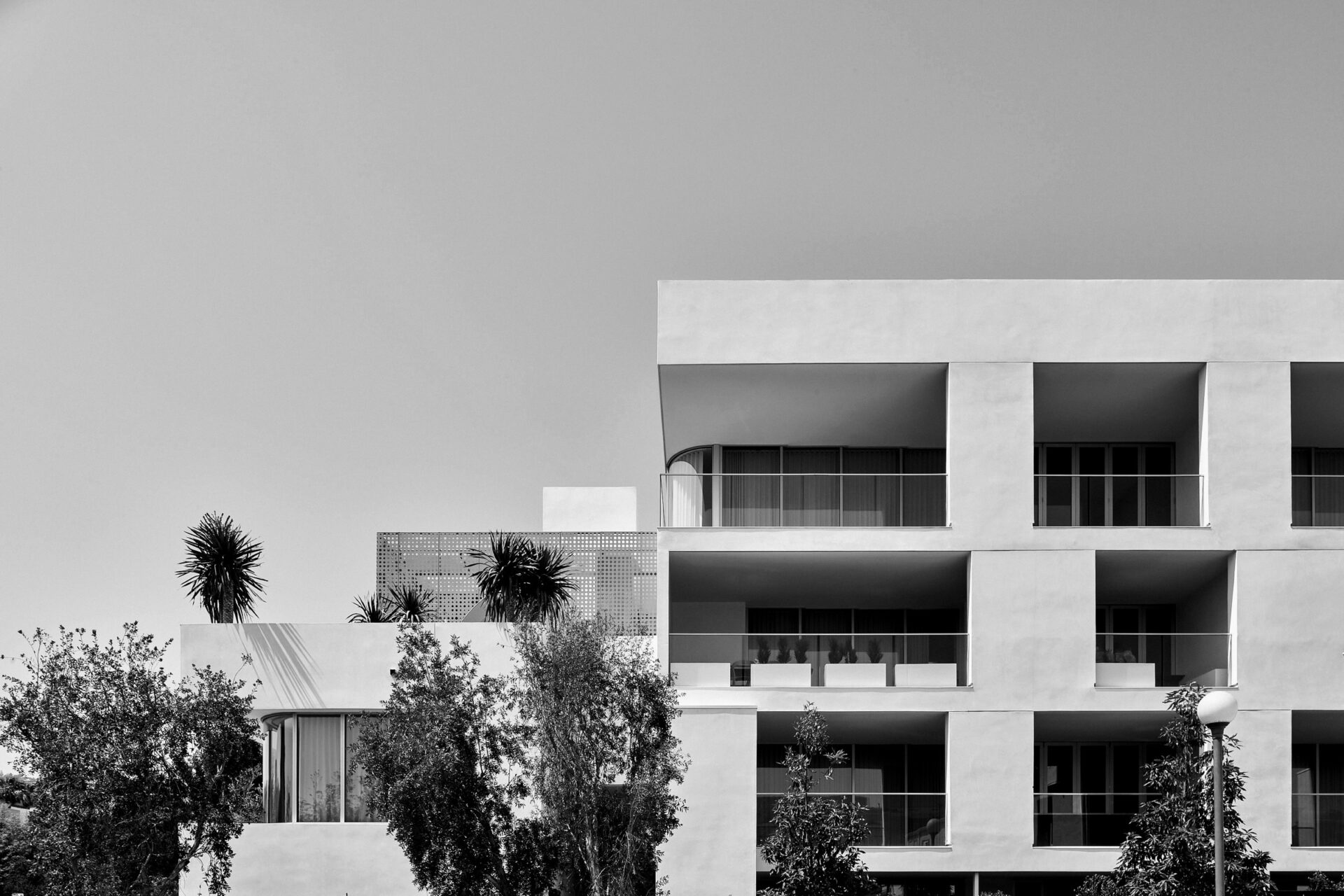Exterior of luxury West Hollywood apartment building with private terraces and geometric façade.