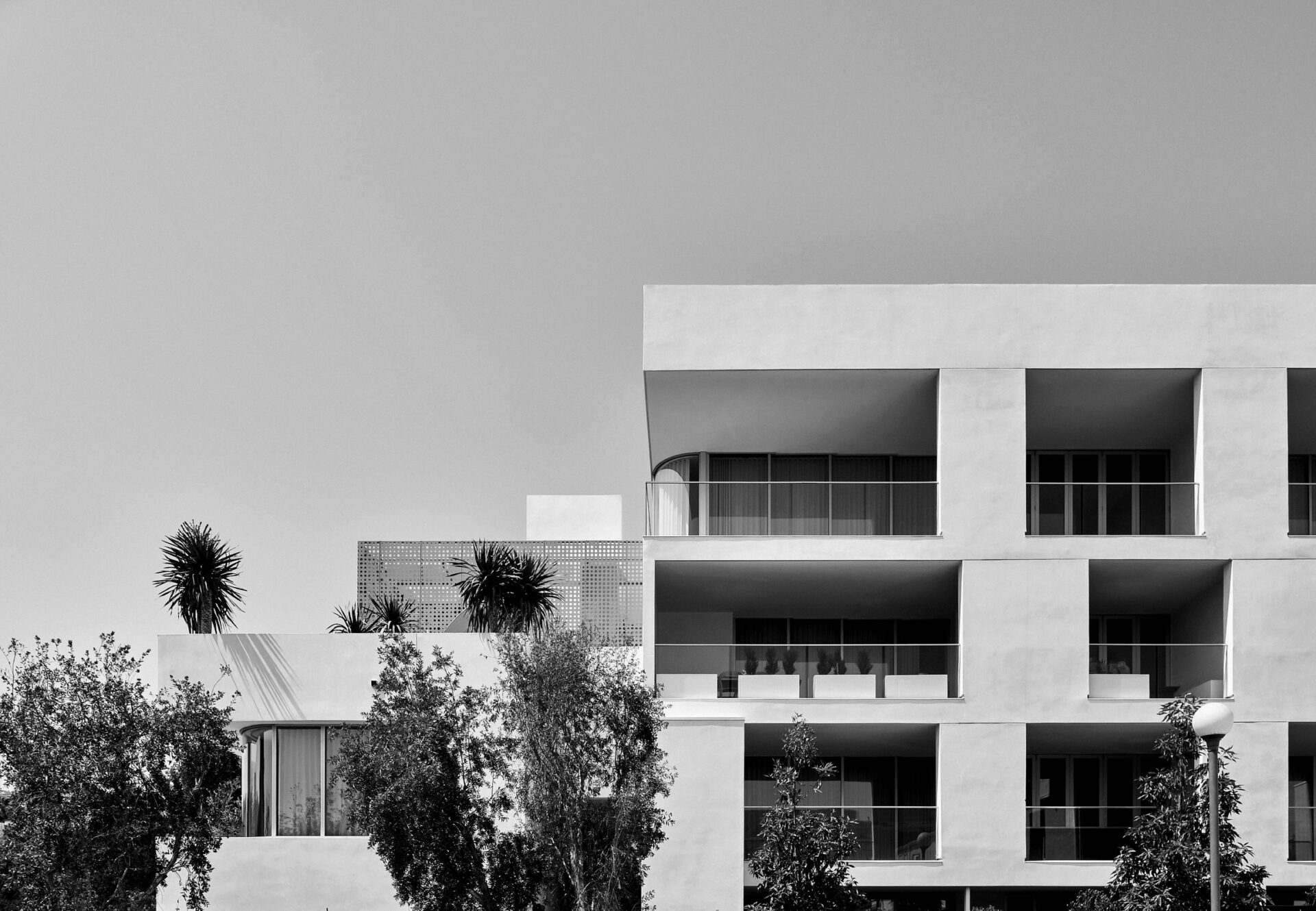 Exterior of luxury West Hollywood apartment building with private terraces and geometric façade.