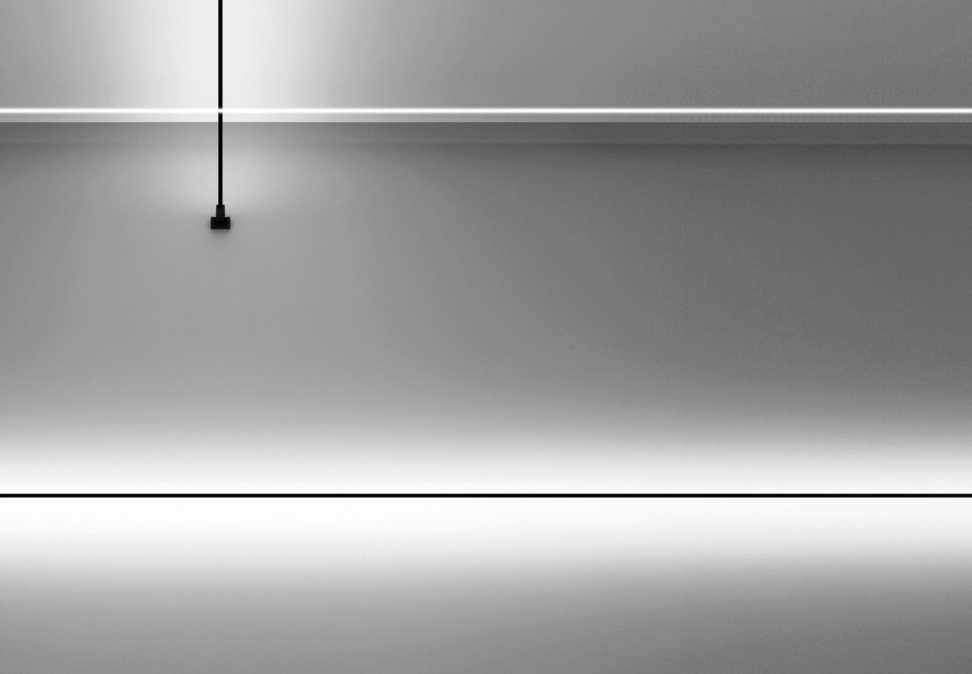 Lucio Fontana-inspired linear lobby lighting at Asteras Kings in West Hollywood, highlighting clean lines and minimalist design.